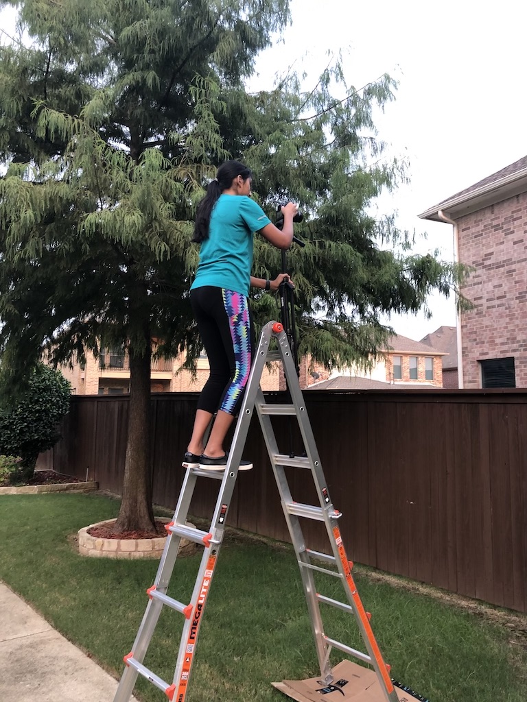 Baani Sandu filming while standing on a ladder